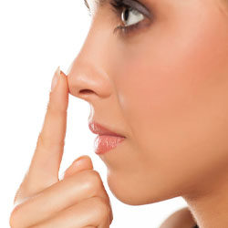 Profile of young woman touching her nose